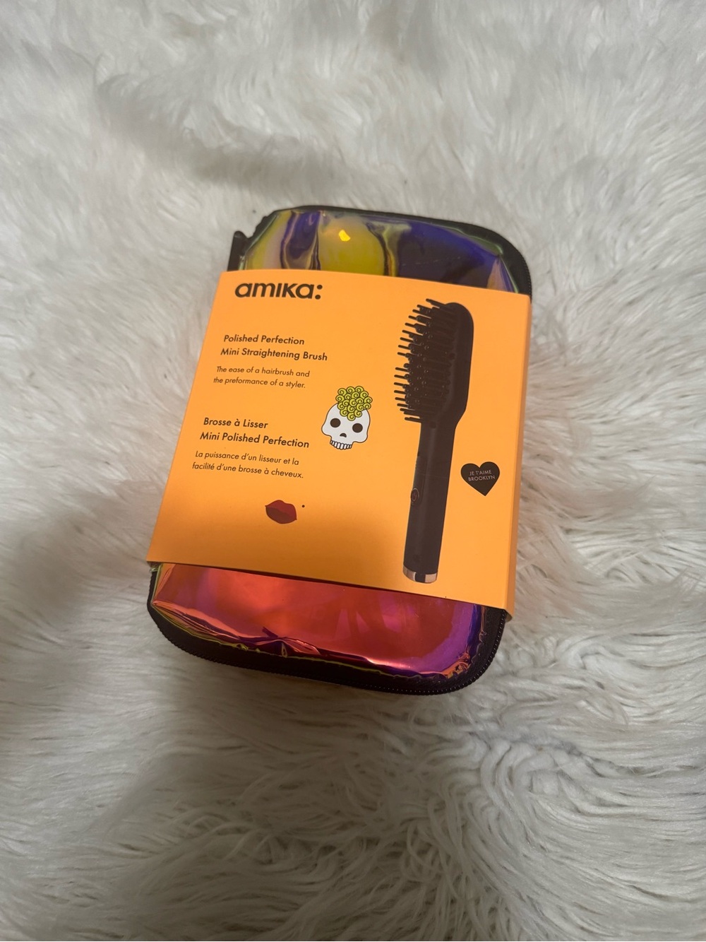amika iridescent pink and purple mini straightening brush with orange sleeve